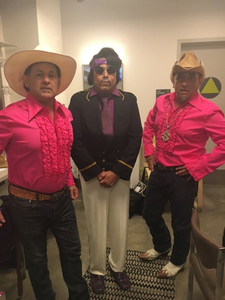 Candid image of Ric Salinas, Herbert Sigüenza, and Richard Montoya dressed for a performance.